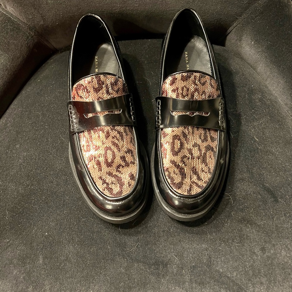 Black leather loafers with sequined leopard embellishments